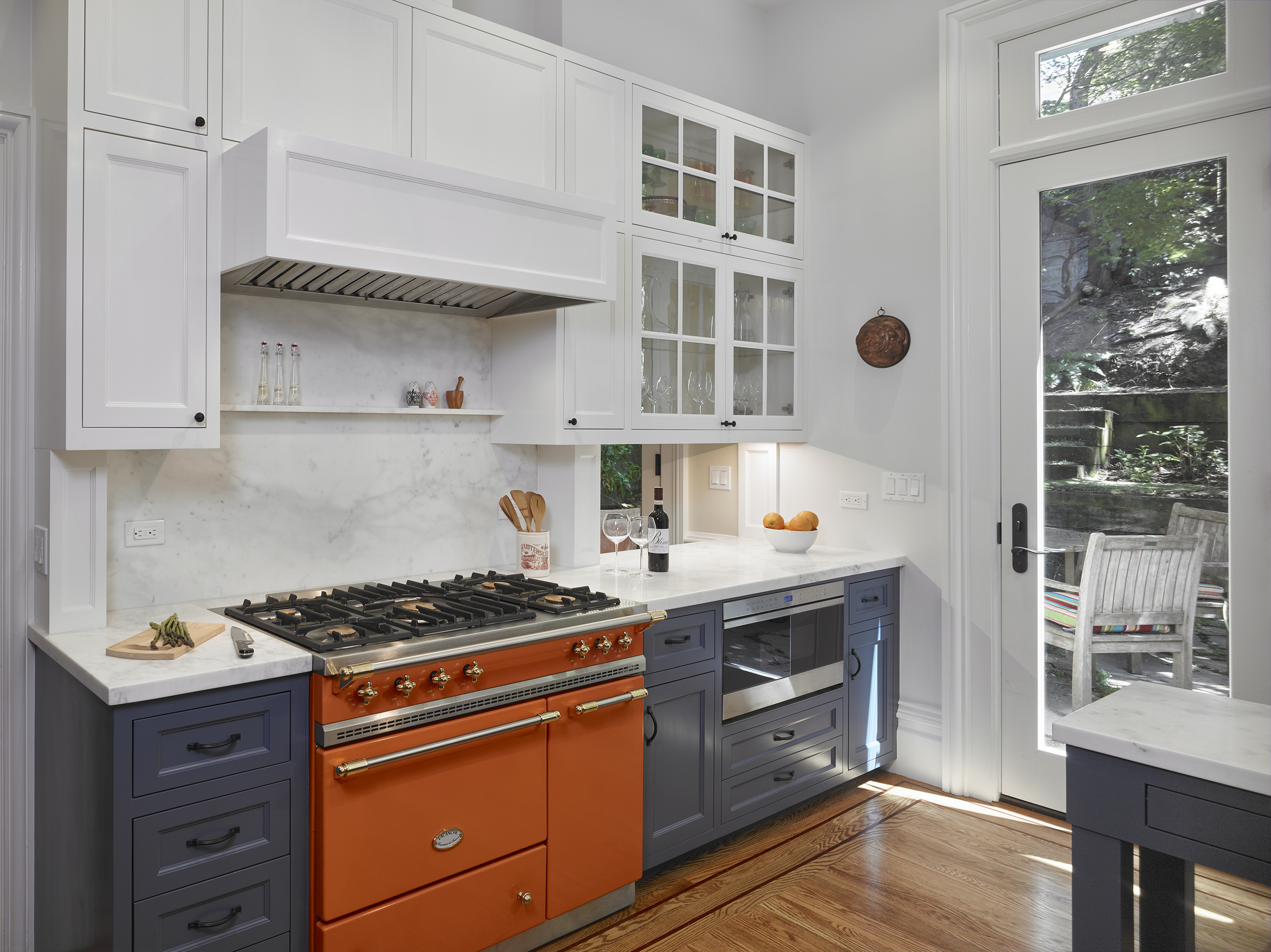 orange stove in blue and white kitchen in renovated victorian