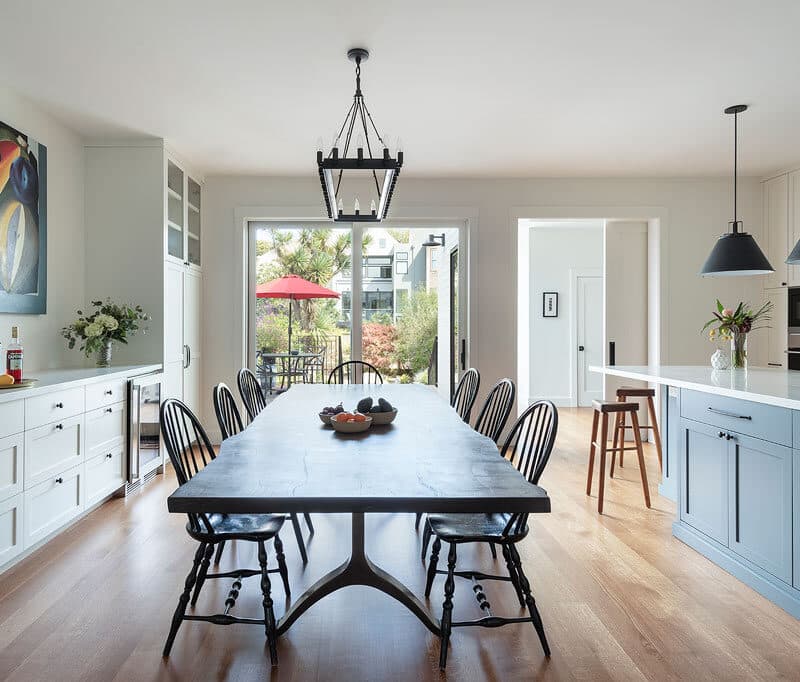 View of backyard from modern open plan kitchen and dining area in San Francisco renovation