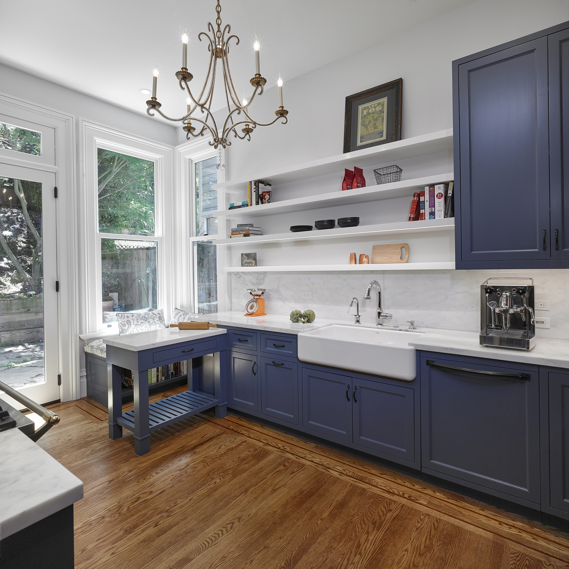 open plan kitchen blue cabinets with victorian chandelier