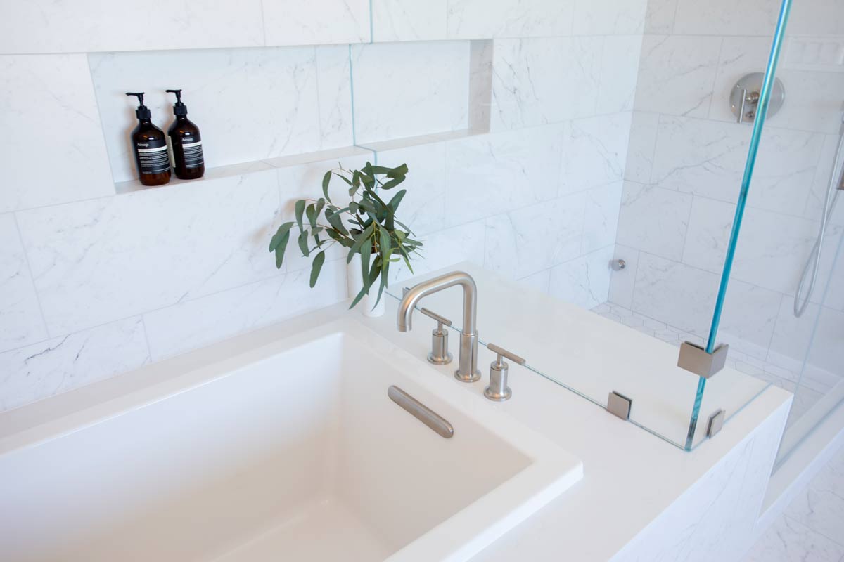 White built-in bathtub with plant